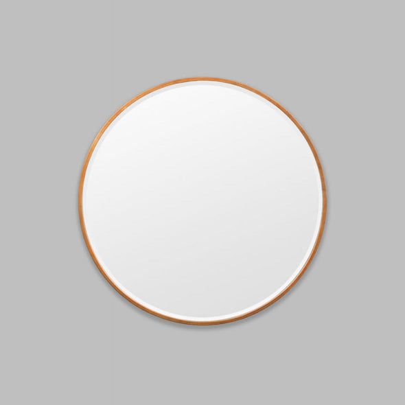 Round Copper mirror on a grey background