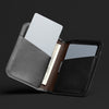 Three card holders in gray, brown, and black on a dark background