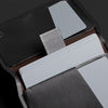 Close-up of a black leather wallet with cards and a silver cardholder.