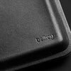 Close-up of a black leather product with 'bellroy' branding.