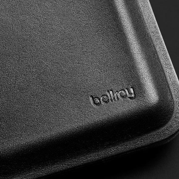 Close-up of a black leather product with 'bellroy' branding.