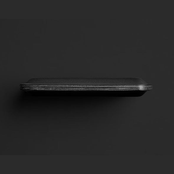 Black rectangular object on a dark background