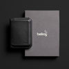 Black wallet and gray box with 'bellroy' logo on a black background