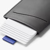 Gray leather cardholder with white cards and a blue accent on a light gray background