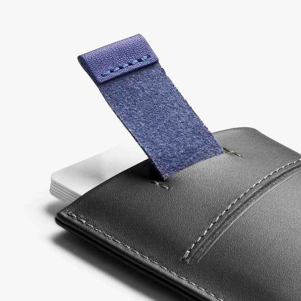 Gray leather wallet with a blue fabric strap on a white background