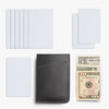 Black leather wallet with cardholder, multiple cards, and a $10 bill on a white background
