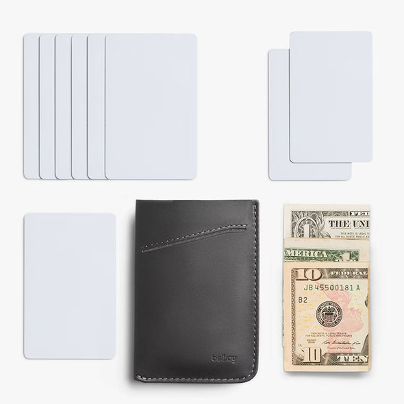 Black leather wallet with cardholder, multiple cards, and a $10 bill on a white background