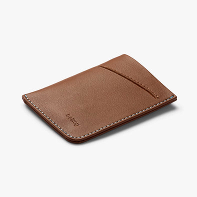 Brown leather cardholder with 'bellroy' branding on a white background
