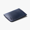 Navy blue leather cardholder on a white background