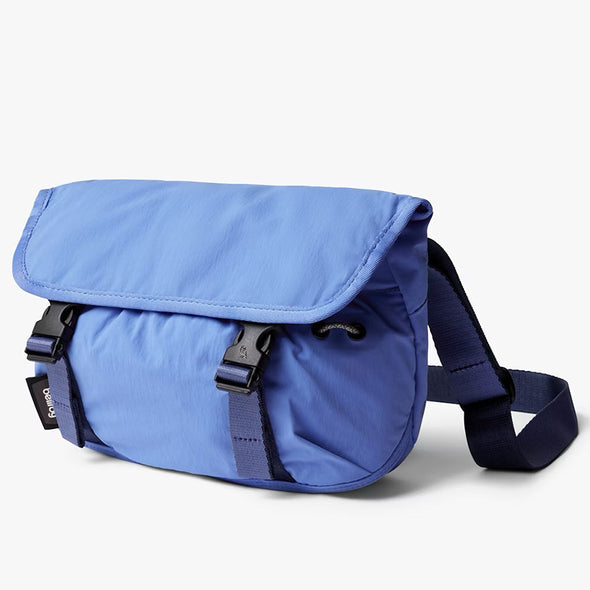 Blue shoulder bag with a strap on a white background