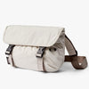 Beige shoulder bag with a strap on a white background
