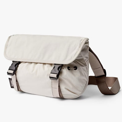 Beige shoulder bag with a strap on a white background