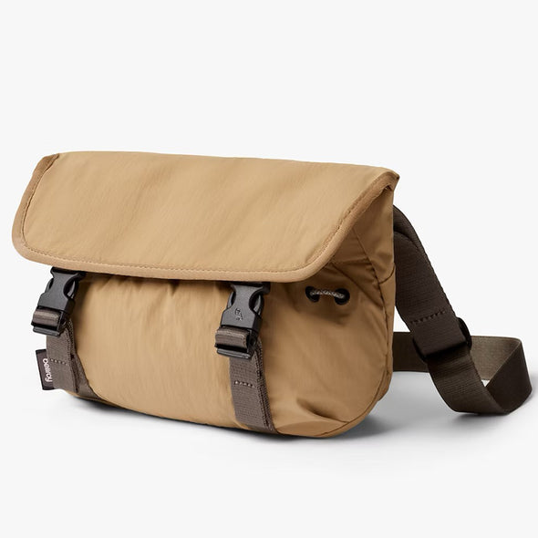 Brown leather bag with a strap on a white background