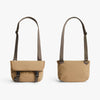 Two beige shoulder bags with brown straps on a white background