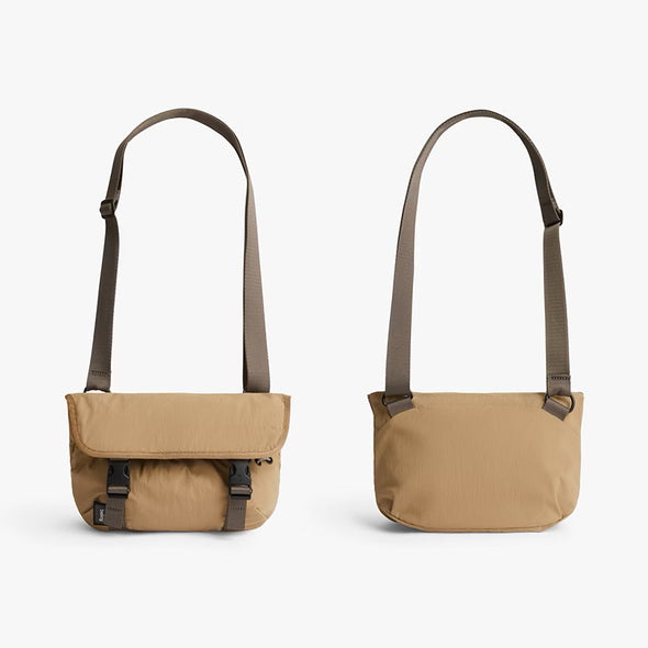 Two beige shoulder bags with brown straps on a white background