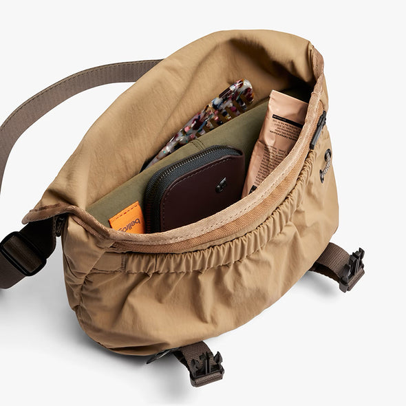 Brown bag with items inside on a white background