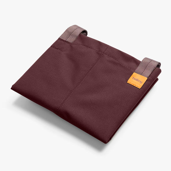 Folded Bellroy City Tote Burgundy with a brand label on a white background