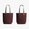 Bellroy City Tote Burgundy tote bags with gray handles on a white background