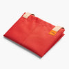 Red bag with beige straps and a visible brand tag on a white background