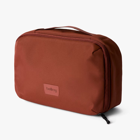 Brown toiletry bag with 'bellroy' logo on a white background