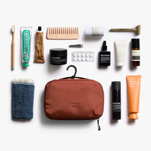 Collection of grooming products including a toothbrush, comb, and bottles on a white background