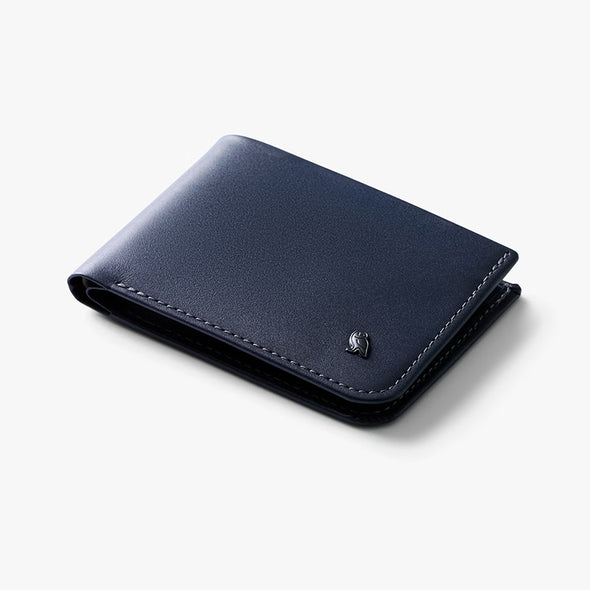 Navy blue leather wallet with a brand logo on a light gray background