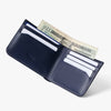 Navy leather wallet with money and cards on a white background