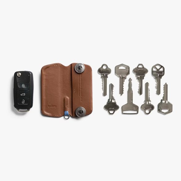 Brown leather key organizer with keys on a white background