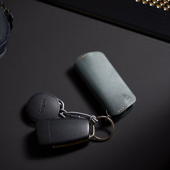 Keychain with key fob and wallet on a dark surface