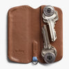 Brown leather key holder with keys on a white background