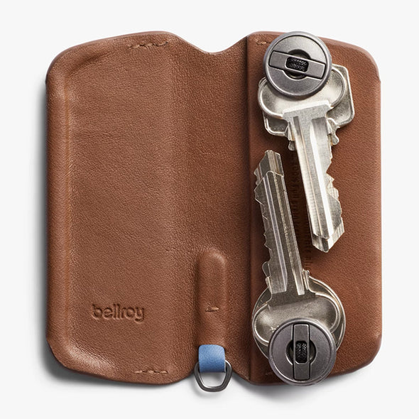 Brown leather key holder with keys on a white background