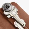 Close-up of a key on a brown leather surface