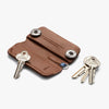 Brown leather key holder with keys on a white background
