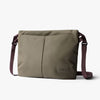 Green shoulder bag with a visible brand logo on a white background