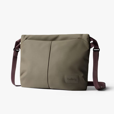 Green shoulder bag with a visible brand logo on a white background