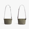 Two beige shoulder bags with brown straps on a white background