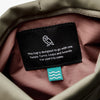 Close-up of a label on a bag with text and a logo.