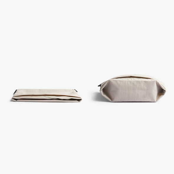 Beige fabric pouch and folded fabric on a white background