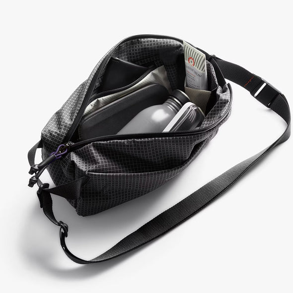 Black crossbody bag with a shoulder strap on a white background