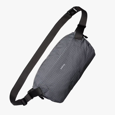 Gray crossbody bag with black straps on a white background