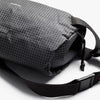 Black textured crossbody bag on a white background