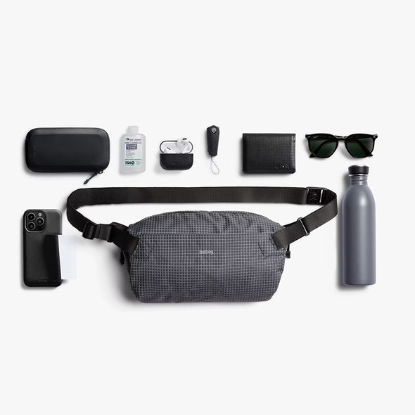 Collection of items including a gray waist bag, phone case, water bottle, and accessories on a white background.