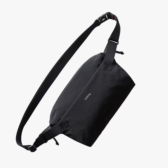 Black sling bag on a white background