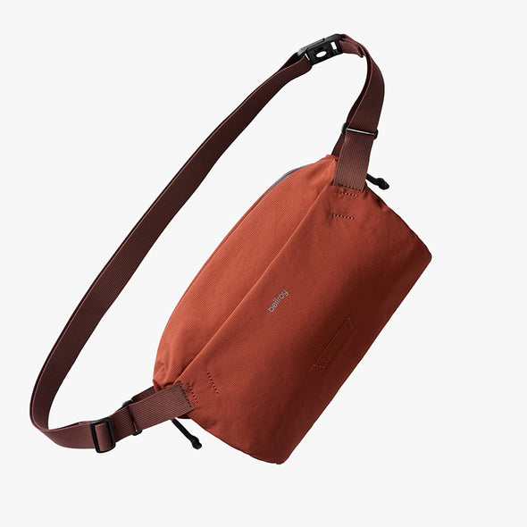 Clay Brown sling bag with a strap on a white background