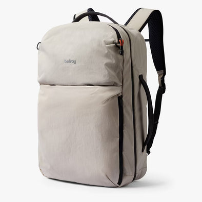 Beige backpack with black straps on a white background