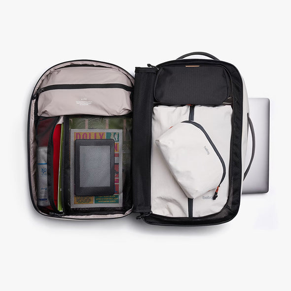 Open travel backpack with organized compartments on a white background