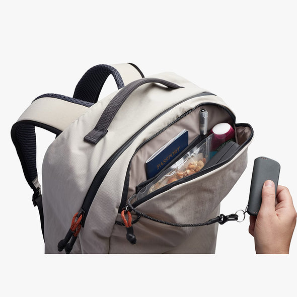 Backpack with a hand holding a phone, on a white background
