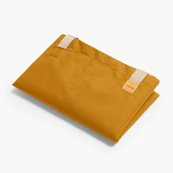 folded Bellroy Market Tote in copper  with two white straps on a white background