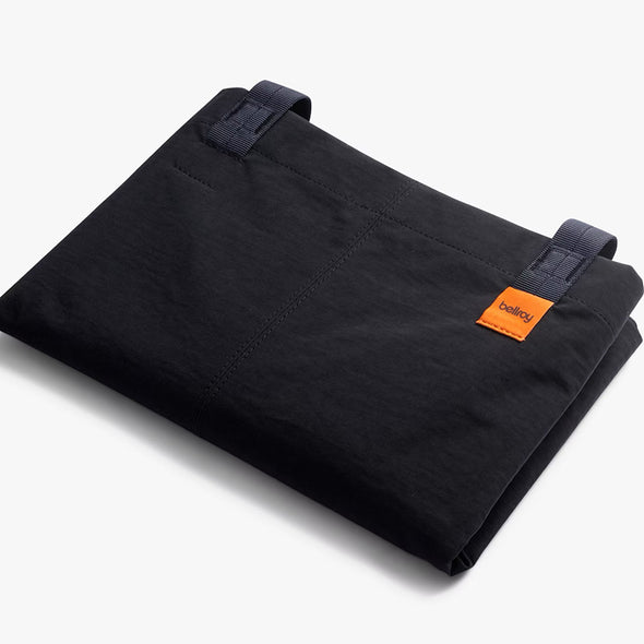 Black bag with an orange label on a white background