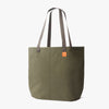 Green tote bag with brown handles on a white background